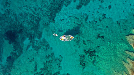 Fototapeta na wymiar Aerial drone photo of picturesque and traditional colourful fishing boat docked in port of Koufonisi island, Small Cyclades, Greece