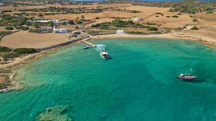 Fototapeta premium Aerial drone photo of picturesque and traditional tourist vessel cruising in famous beaches of Koufonisi island, Small Cyclades, Greece