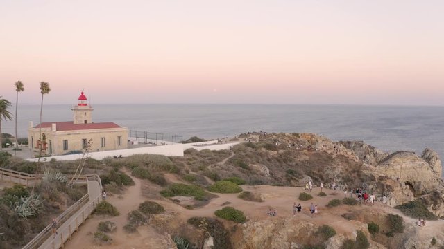 Aerial drone view of Ponta Piedade lighthouse and cliffs, Lagos, Portugal summer, sunset evening time