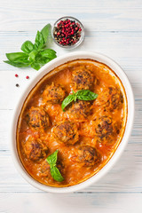 Oven baked meatballs on rustic wooden background. Top view, space for text.