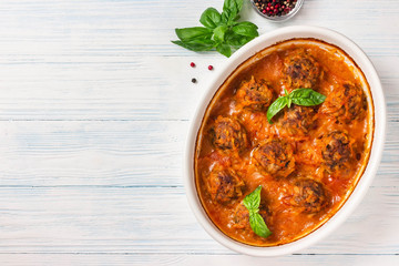 Oven baked meatballs on rustic wooden background. Top view, space for text.