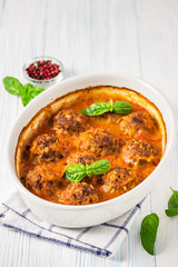 Turkey meatballs in a baking dish. Selective focus, space for text.