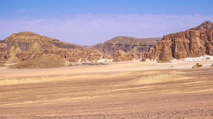 sand dunes and mountain. Desert at sunset - mountain landscape with dust.