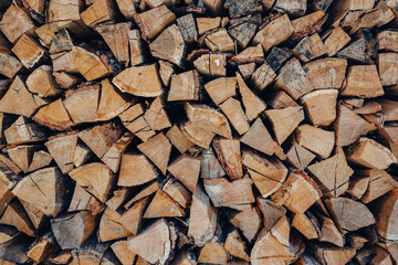 Preparation of firewood for the winter. firewood background, Stacks of firewood in the forest. Pile of firewood.