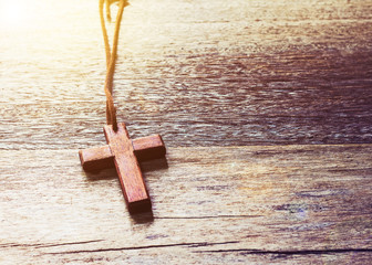 Close up of wooden cross on wooden table