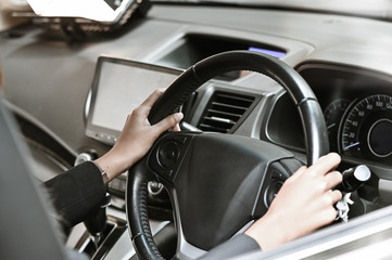 Closeup businesswoman driving on a car.