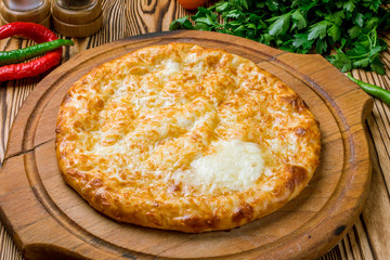 khachapuri with cheese on wooden table