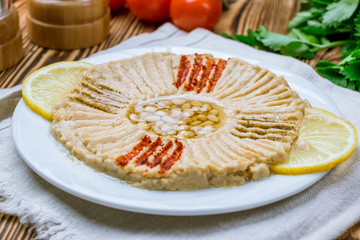 Traditional homemade hummus on wooden table. Turkish cuisine.