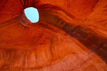 blue sky seen through hole in red rock 