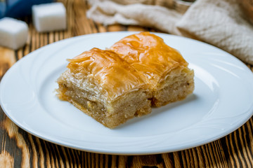 baklava with walnuts on wooden table. Turkish cuisine