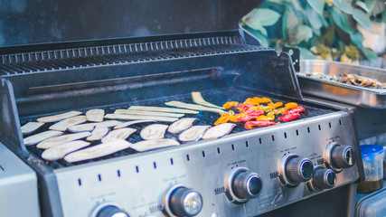 Sliced zucchini, grilled, picnic with barbecue in the open air. squash barbecue roasted on metal grill. Diet vegan bbq.