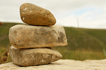Balanced stones on the alpine meadow near caucasus mountains