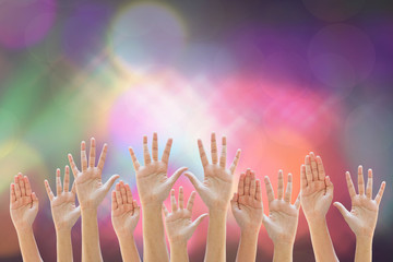 Mixed empty raise up hands  on  colorful lighting background with copy space  can be used for your text or Christian background, praise and worship concept