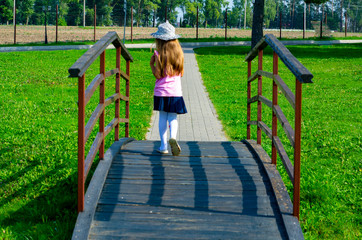 child 6-7 years old plays in the park