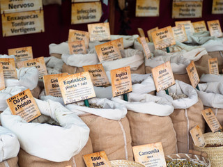 Braga, Portugal - May 23, 2019: Spices, seeds and herbs in jute bags in the street market that took place during the Roman fest, a local tradition that celebrates the city's roman past. 
