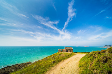 Old Stone House on and Turquoise Blue Atlantic Coast of Pléneuf-Val-André in Brittany France on a Sunny Summer Day
