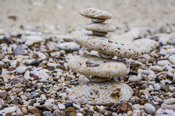 Fototapeta na wymiar Beautiful beige sea stones pyramid