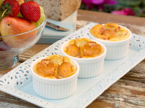 Miniture Ham Souffles In Ramakin Bowls In Outdoor Garden Setting.