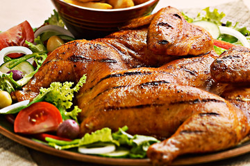 Portugese grilled spatchcock chicken on a bed of salad