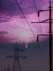 Power line pillar. High-voltage power lines at sunset.
