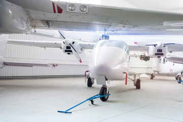 High-winged twin-engined light airplanes in hangar
