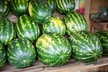 Watermelons in the market. Big berry. Juicy watermelon lies on the counter. Southern fruit.