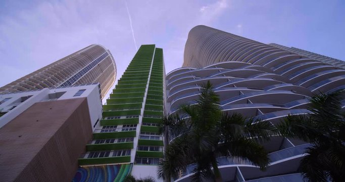 Lo angle facing up towards highrise architecture and palm trees Miami 4k 60p