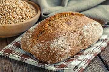 loaf of bread on wooden background, food closeup.Fresh homemade bread.French bread. Bread at leaven. Unleavened bread.Ciabatta bread.