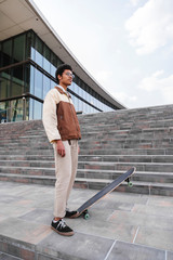 African skateboarder stands and lifts skate in air