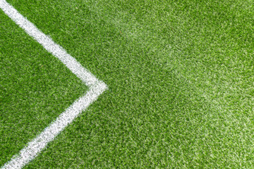 Fototapeta premium Green synthetic artificial grass soccer sports field with white corner stripe line