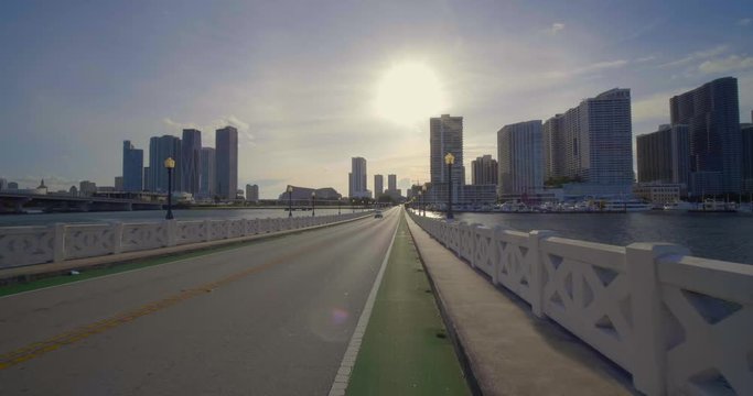 Cyclists pov biking on the Venetian Causeway Miami Beach towards downtown 4k 60p