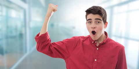 young teenage man showing strength
