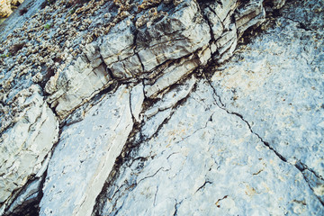 The texture of the stone and lichen on it. Stone faults