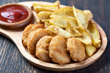 Tasty fried nuggets and potatoes