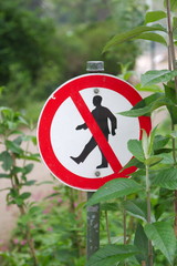 Do not cross. Pedestrians are not allowed behind that sign.