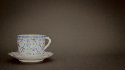 A Porcelain cup with black background an copy space