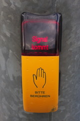 A german signal button on a traffic light.