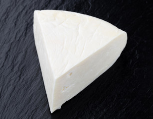 Cheese on a slate surface. Piece of cheese close-up.