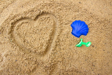 Fototapeta na wymiar A heart in the sand with copy space