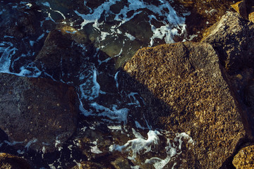 rocks at the bottom of a clear sea water - image