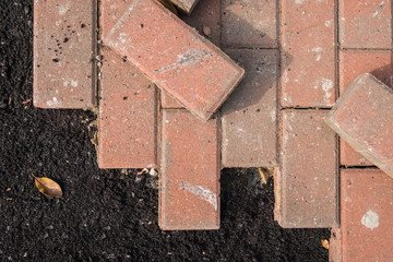 Laying bricks on a sidewalk