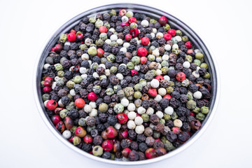 Top view dry pepper mix. Black, white, green and red pepper.
