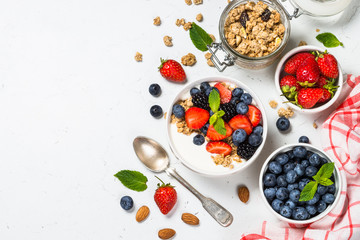 Greek yogurt granola with fresh berries on white table.