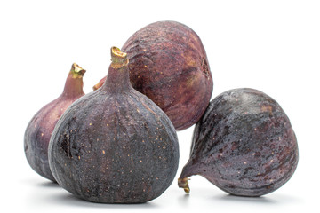 Group of four whole fresh fig fruit isolated on white background