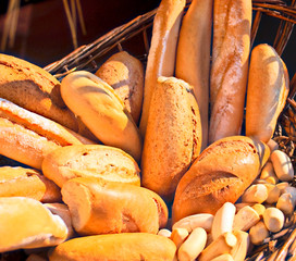 Breads in different shapes and size in a wicker basket