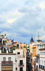 Facades of old houses in various colors in Seville the capital city of Andalucia in Spain in a cloudy day.