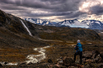 Hiker in Jotunheimen NP looking at hurrungane mountains