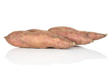 Group of three whole fresh brown sweet potato isolated on white background