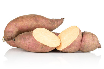 Group of two whole two halves of fresh brown sweet potato isolated on white background