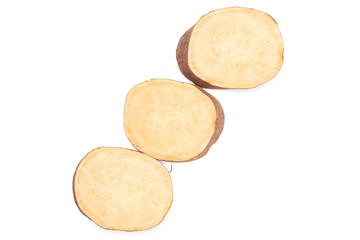 Group of three slices of fresh brown sweet potato flatlay isolated on white background